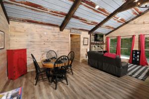 a room with a table and chairs and a couch at Newly renovated 2 BR in convenient location! in Sevierville