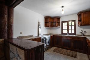 a kitchen with wooden cabinets and a counter top at GuestReady - Rustic Oasis in Vila Nova de Cerveira in Vila Nova de Cerveira