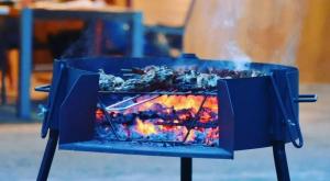 a blue stove with a fire in it at Casa con vistas, piscina y animales de granja, LA CASETA in Tarragona