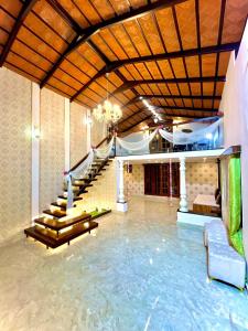 a large room with a pool of water and stairs at Aaloka stay in Mysore