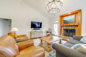 a living room with a couch and a fireplace at Incredible Lake Glenville Views Cashiers Home in Cashiers
