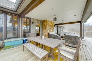 a patio with a table and chairs on a deck at Incredible Lake Glenville Views Cashiers Home in Cashiers