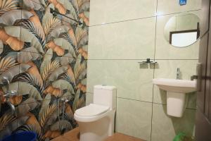 a bathroom with a toilet and a sink at You and Me in Varkala