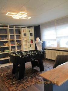 a living room with a foosball table in the middle at Schneider House in Ramstein-Miesenbach