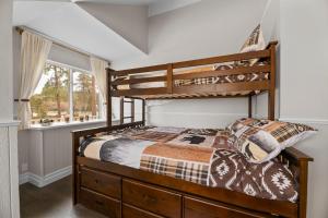 a bedroom with a bunk bed and a window at Bunny's Ranch - Sleeps 12, Pool Table, Ping Pong, Foosball in Big Bear City