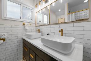 a white bathroom with a sink and a mirror at Bunny's Ranch - Sleeps 12, Pool Table, Ping Pong, Foosball in Big Bear City +36 photos