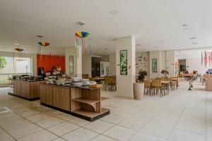 a large room with tables and chairs and kites at Atrium Thermas - OFICIAL in Caldas Novas
