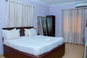 Rúm í herbergi á Triple Tee Hotel