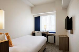 Televiisor ja/või meelelahutuskeskus majutusasutuses Four Points Flex by Sheraton Shin Osaka