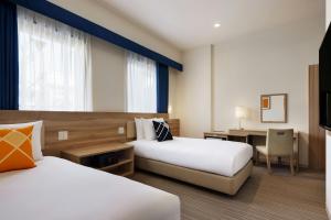 Voodi või voodid majutusasutuse Four Points Flex by Sheraton Shin Osaka toas
