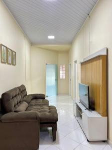 ein Wohnzimmer mit Couch und Flachbildfernseher in der Unterkunft Casa Açaí in Bragança