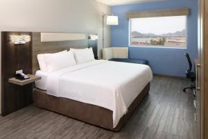 a hotel room with a large bed and a window at Holiday Inn Express Manzanillo by IHG in Manzanillo