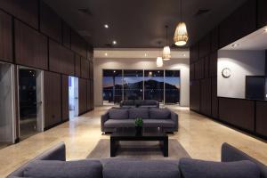 a large living room with couches and a tv at Holiday Inn Resort Mazatlan by IHG in Mazatlán