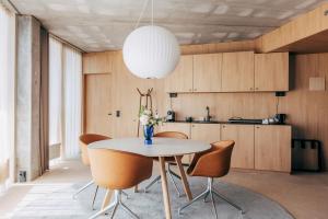 a kitchen and dining room with a table and chairs at A Place To Hotel Esbjerg in Esbjerg