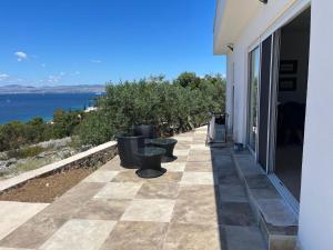 a balcony of a house with a view of the ocean at Kuća za podmor Olea in Nečujam +3 photos