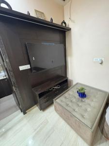 a living room with a large flat screen tv at Mathura Bliss Resort Villa in Mathura
