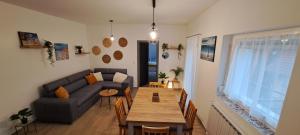 a living room with a couch and a wooden table at Aqua apartmanház Gyenesdiás in Gyenesdiás