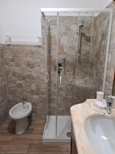a bathroom with a shower and a toilet and a sink at apartment Ravelli in Piano +16 photos