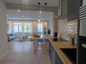 a kitchen and living room with a table and chairs at Canido con vistas in Ferrol