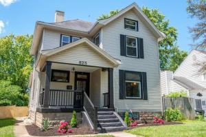a white house with black windows at Main Street Oasis Pool and Hot Tub Sleeps 8 in Hamilton