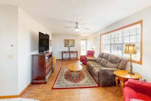 a living room with a couch and a tv at The Cozy Corner in Bentonville