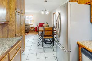 a kitchen with a refrigerator and a table with chairs at The Cozy Corner in Bentonville