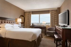 a hotel room with a bed and a television at The Park Hotel at Meadowlands in East Rutherford