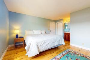 a bedroom with a large white bed and a blue wall at Bayfront Retreat B in Port Ludlow +22 photos
