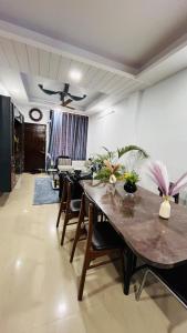 a living room with a table and a couch at Premium 3 Bedroom Independent Villa in Indore
