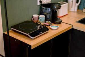 a counter with a coffee maker and a laptop on it at Le studio tendance in Albi