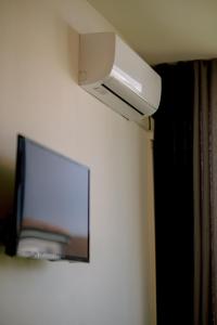 a flat screen tv hanging on a wall at Le studio tendance in Albi
