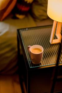a cup of coffee sitting on a glass table at Le studio tendance in Albi