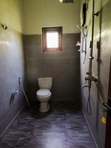 a bathroom with a toilet and a window at Air Ray Homestay in Negombo