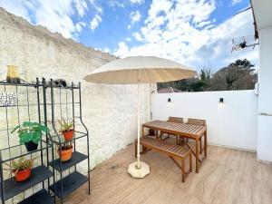 a patio with a table and an umbrella at Apartamento Peñaquinera En Llanes in Llanes