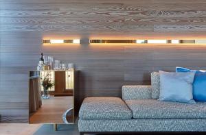 a living room with a couch and a bar at Kempinski Hotel Berchtesgaden in Berchtesgaden +37 photos