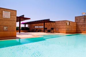 a swimming pool in front of a building at Raphael Suites in Johannesburg