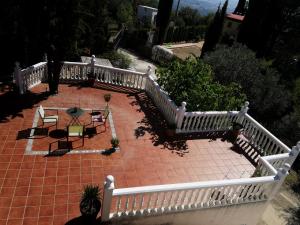 eine Veranda mit einem weißen Zaun sowie einem Tisch und Stühlen in der Unterkunft Sombrerocordobe in Córdoba