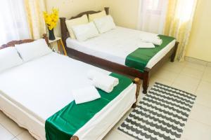 Postel nebo postele na pokoji v ubytování Bamburi BnB