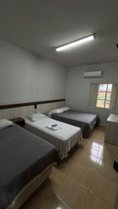 Postel nebo postele na pokoji v ubytování Hotel Brasil
