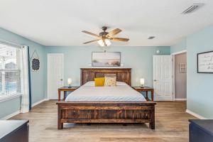 a bedroom with a bed and a ceiling fan at 8347 Shipton St in Navarre +31 photos