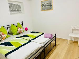 a bed with colorful pillows on it in a room at Ferienwohnung Sommerblüte in Schweich