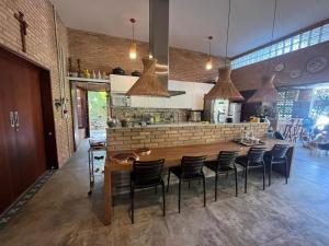 a kitchen with a large wooden table and chairs at Casa dos Sonhos em São Miguel dos Milagres in São Miguel dos Milagres
