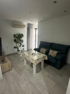 a living room with a couch and a table at Bellavista in Setenil