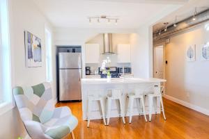 a kitchen with a large island with bar stools at Jennifer's Amazing City View Private Apartment in Providence