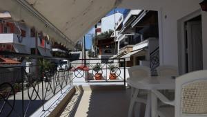 a balcony with a table and chairs on a building at 2 bedroom equipped apartment Stellios in Sarti