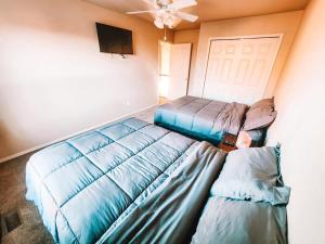 a room with two beds and a ceiling fan at Hot Tub, King Beds, Pet Friendly Close to I25 in Fountain