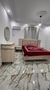 a bedroom with a bed and a vanity and a mirror at Appartement S3 CHIC à Mahdia 2étages in Mahdia