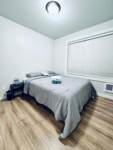 a bedroom with a bed and a large window at Newly built home, ample parking, near SEA Airport in Tukwila