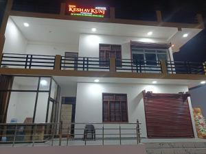 two levels of a building with a balcony at Hotel Keshav Kunj in Ayodhya