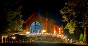 a house with lights on the side of it at night at Black Bear Lodge Reduced Nightly Rate in Bass Lake
